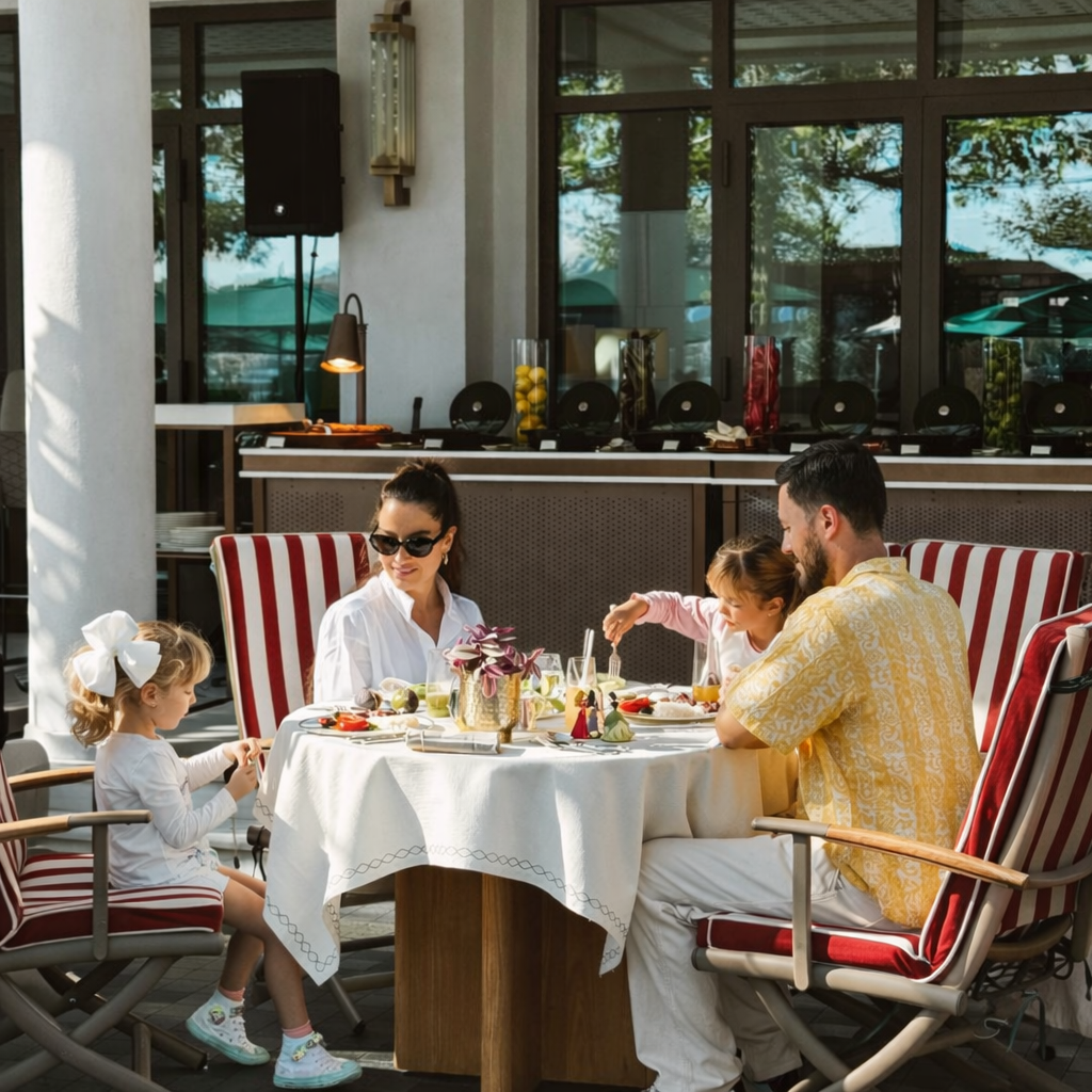 new-westminster-local-community-life-brewery-dining-scene-family-lunch-on-patio-with-red-striped-chairs-and-little-girl-white-bow