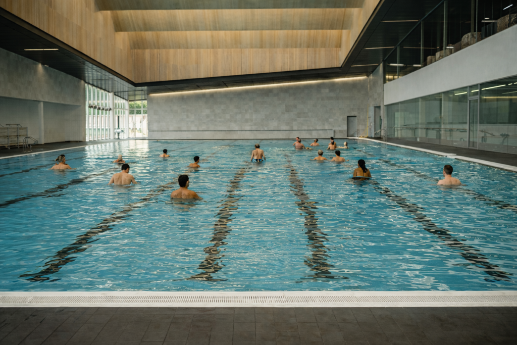 new-westminster-local-indoor-swimming-pool-with-people-in-and-around-the-water-candid-modern-community-aquatic-centre