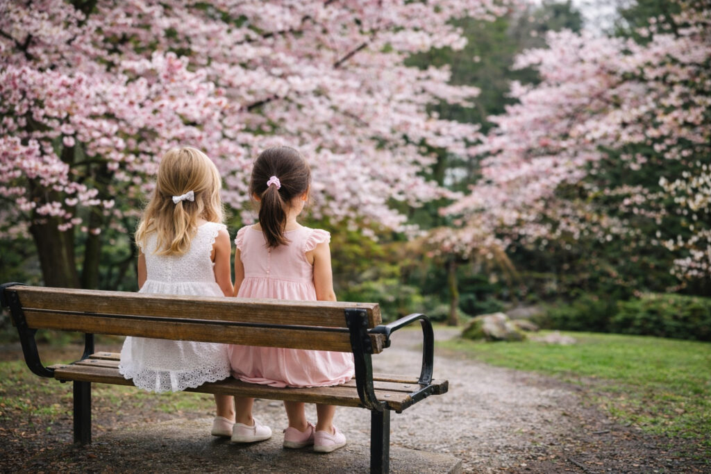 Tipperary Park-two-girls-sitting-on-bench-among-cherry-blossoms-directory-New Westminster