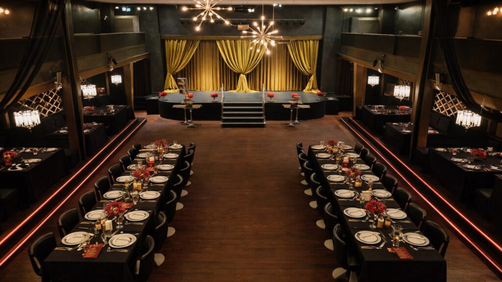 theatre-interior-with-formal-dining-tables-stage-and-chandeliers-at-new-westminster-entertainment-venue-for-rainy-days