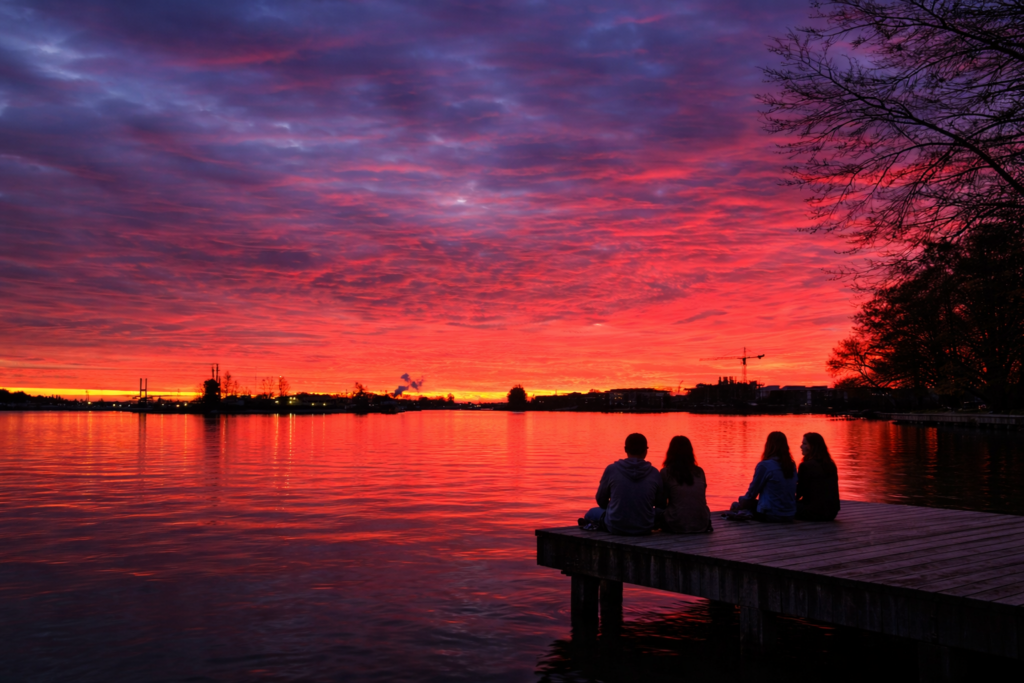 sunset-over-lake-with-friends-sitting-on-dock-new-west