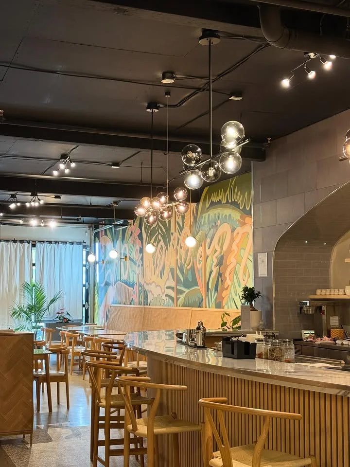 halina dining room and bar HALINÁ Modern Filipino Kitchen + Bar The Halina dining room on East Hastings Street, with a long bar, wooden chairs and pendant lights