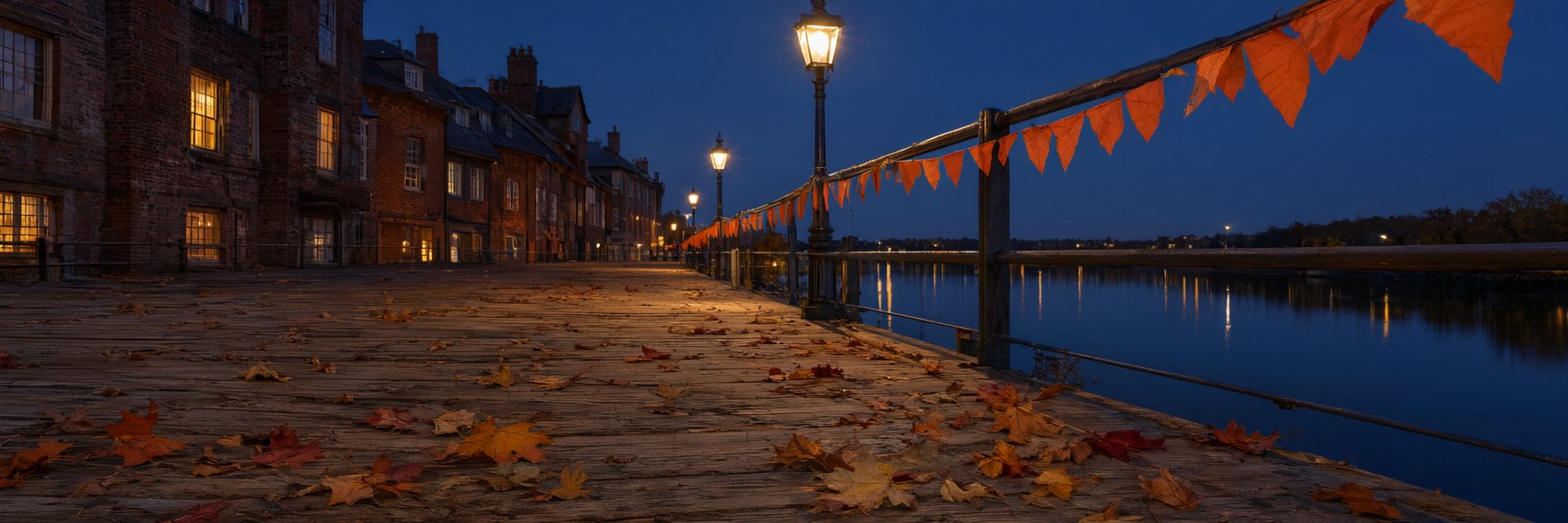 halloween newwestminster banner v3 Halloween Ideas and Events in New Westminster, BC A riverside boardwalk at dusk on October 31, strung with orange bunting along the railing, warm lit windows of old brick buildings behind and the river reflecting the lights